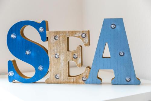 a large metal letter fa sitting on top of a shelf at Sunny Old Town Apartment in Koper