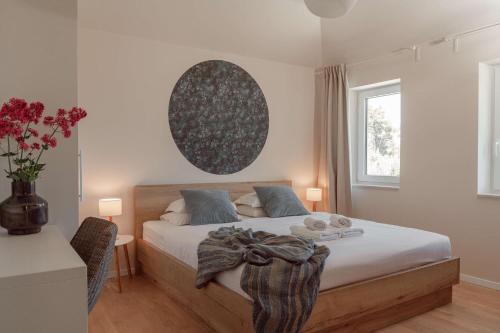 a bedroom with a bed and a table and a window at Villa Anouk in Pitve