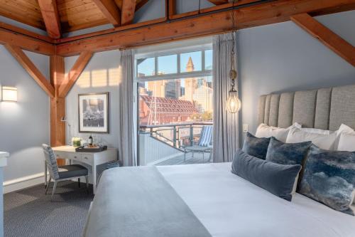 a bedroom with a bed and a view of the city at Boston Yacht Haven in Boston