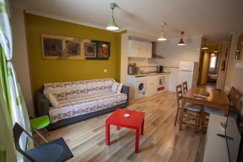 a living room with a couch and a table at Apartamentos Rurales Romero in Nohales