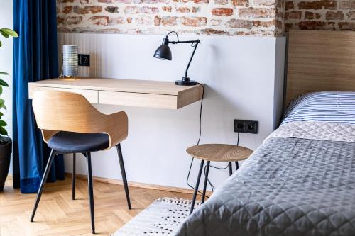 a bedroom with a desk and a bed and a desk and chair at OnLviv Apartments Rynok Square 18/2 in Lviv