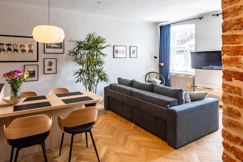 a living room with a couch and a table at OnLviv Apartments Rynok Square 18/2 in Lviv