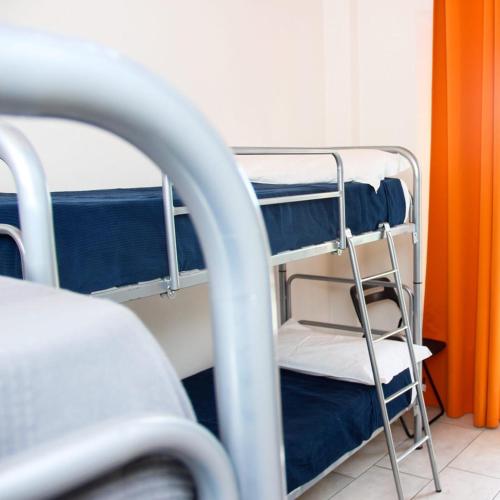 a room with two bunk beds and a ladder at Ostello La Salana in Capannori