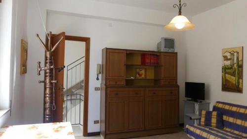 a living room with a cabinet and a television at Appartamento fronte mare San vito lo capo in San Vito lo Capo