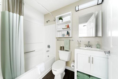 a white bathroom with a toilet and a sink at InTown Suites Extended Stay Austin TX - Research Blvd in Jollyville