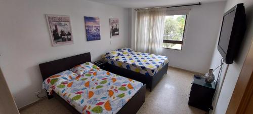 Postel nebo postele na pokoji v ubytování Amplio Apartamento en Los Colores