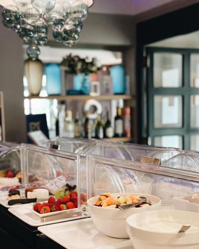 a buffet with fruits and vegetables in plastic containers at Hotel du Nord, Hamburg-Volksdorf in Hamburg