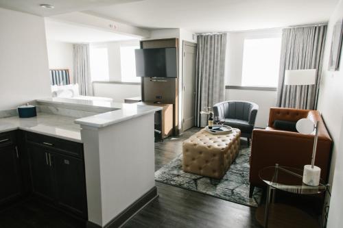 a kitchen and living room with a couch and a chair at Hotel Legends in Biloxi