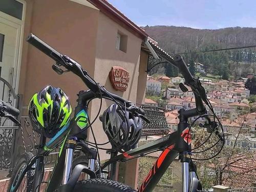 two bikes parked next to a building with helmets on them at Casa Mular in Kruševo