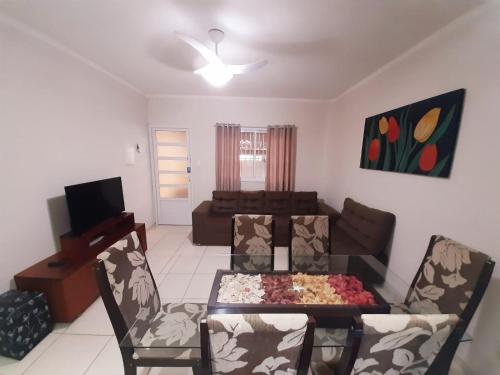 - un salon avec un canapé, une table et des chaises dans l'établissement Ótima casa em Ubatuba, à Ubatuba