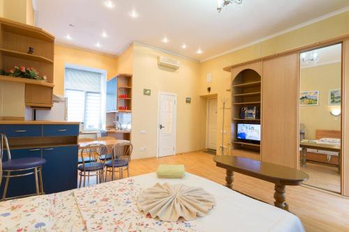 a kitchen and living room with a table and chairs at Central Area Apartments in Kyiv