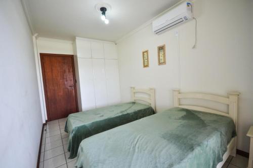 เตียงในห้องที่ 1038 - Apartamento com vista para o mar na Avenida De Bombinhas