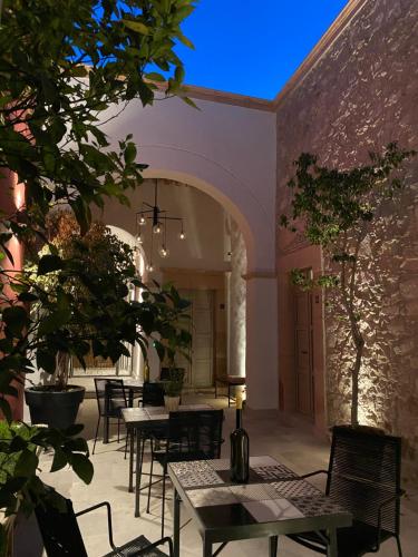 a patio with tables and chairs in a building at Hotel Casa Once in Querétaro