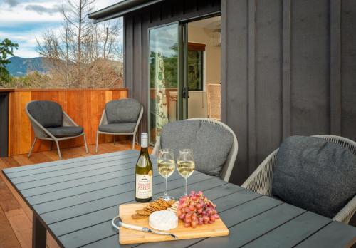 a table with a bottle of wine and wine glasses at 'Love' Hanmer Couples Retreat Limited in Hanmer Springs