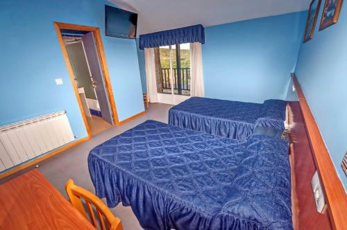Hotel Medulio tesisinde bir odada yatak veya yataklar