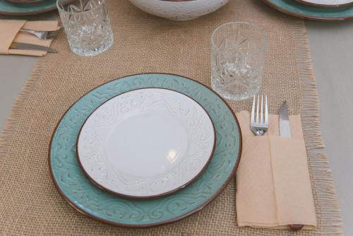 a plate sitting on a table with a fork and knife at Sul Mare in Diakopto