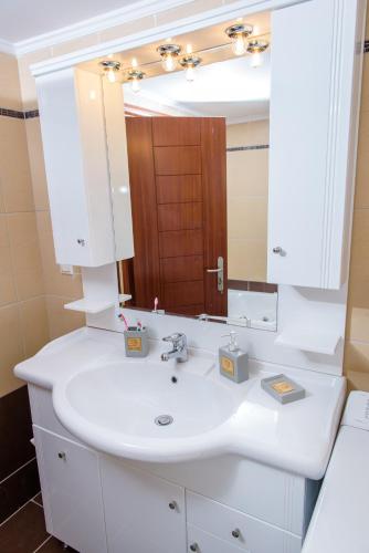a bathroom with a white sink and a mirror at Sul Mare in Diakopto