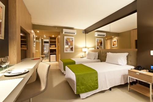 Cama ou camas em um quarto em eSuites Savassi Toscanini