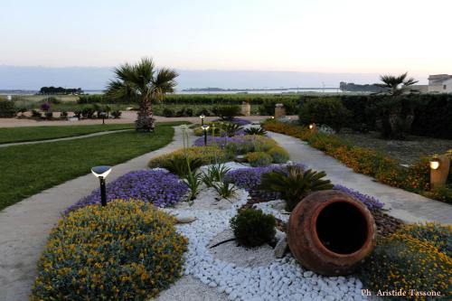 a garden with purple flowers and a walkway at Borgo della Luna in Birgi Vecchi