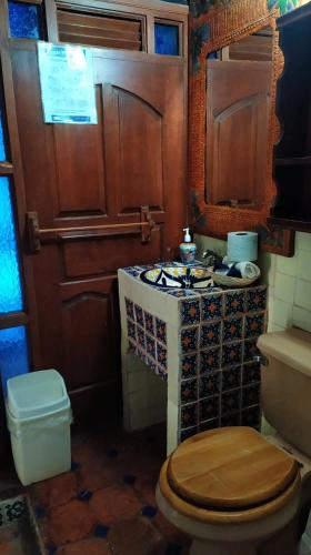 a small bathroom with a toilet and a stove at Casa Azul in Guanajuato