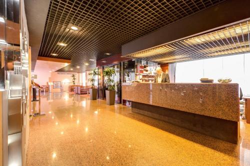 a lobby of a restaurant with a counter at Hotel Galileo in Milan