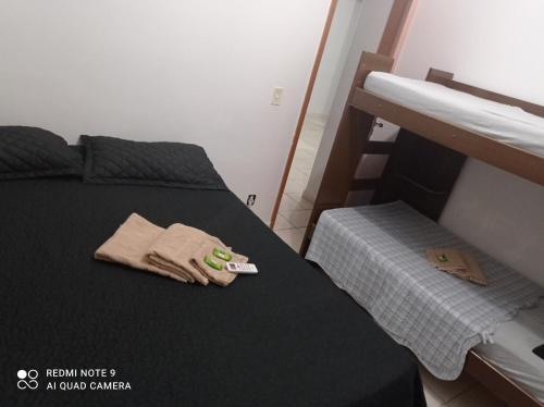 a bedroom with a bed with a pair of gloves on it at Lua E Agua X in Campos dos Goytacazes
