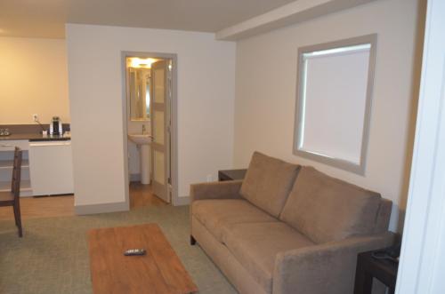 a living room with a couch and a table at Basalt Mountain Inn in Basalt