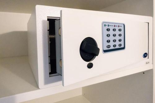 a white electrical box with a remote control on a shelf at HouseBoat next to AMSTEL in Amsterdam