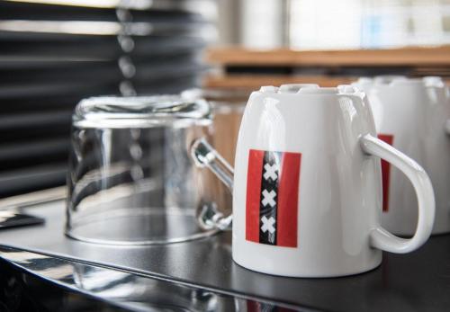 a white coffee mug with an american flag on it at HouseBoat next to AMSTEL in Amsterdam