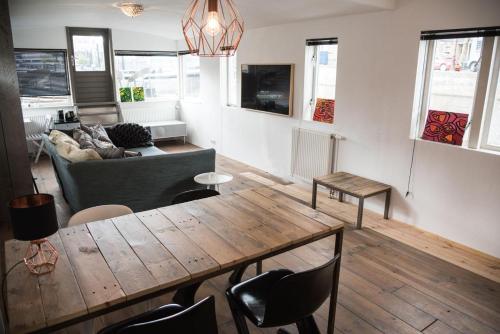 a living room with a table and a couch at HouseBoat next to AMSTEL in Amsterdam
