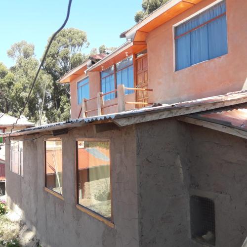 a house under construction with windows on top of it at TAQUILE HOSPEDAJE Pablo in Huillanopampa