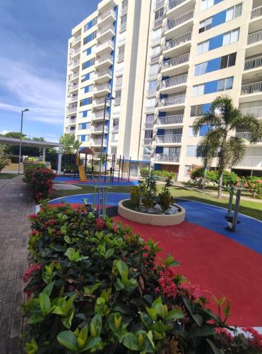 a large apartment building with a red carpet and flowers at INCREIBLE APARTAMENTO Puerto Azul Club House RICAURTE in Ricaurte