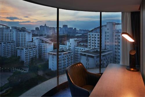a room with a table and a view of a city at Park Plaza Beijing Science Park in Beijing