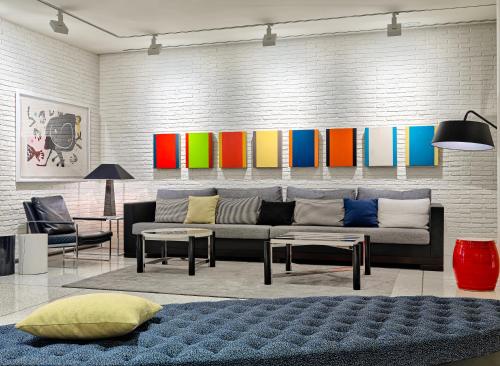 a living room with a couch and a colorful wall at H10 Art Gallery 4* Sup in Barcelona