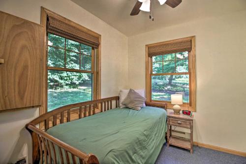 a bedroom with a bed and two windows at Waterfront Leech Lake Cabin with Dock, Fire Pit in Cass Lake