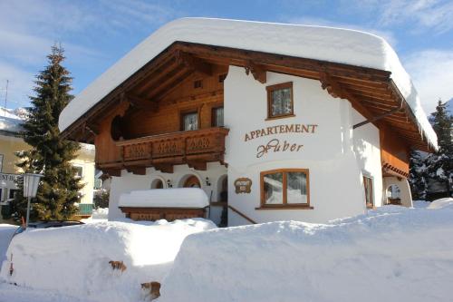 a building covered in snow in front at Appartement Huber in Pertisau