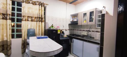 a small kitchen with a counter and a sink at Melgar-Tolima Casa la estrella in Melgar