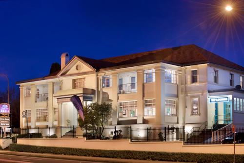 a large white building on a street at night at Grand View Hotel in Wentworth Falls