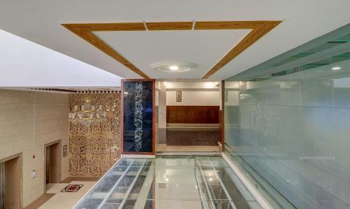 a hallway with a glass floor in a building at Treebo Premium Pearl Avenue Banquets And Lawn in Dehradun