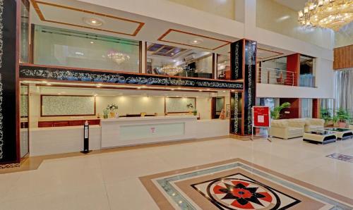 a lobby with a reception desk in a building at Treebo Premium Pearl Avenue Banquets And Lawn in Dehradun