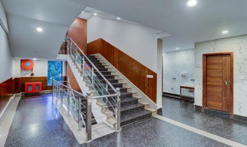 a spiral staircase in a room with a door at Treebo Premium Pearl Avenue Banquets And Lawn in Dehradun