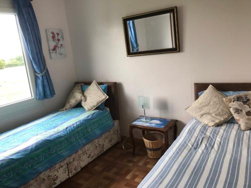 En eller flere senge i et værelse på Le Cottage