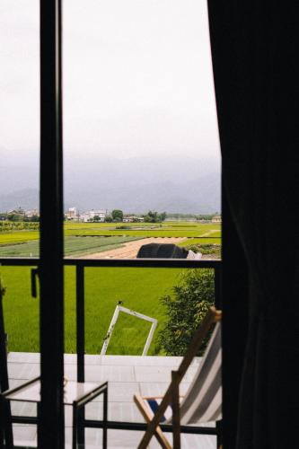 a view of a field from a window at 禾田遇民宿 Hetianyu in Sanxing