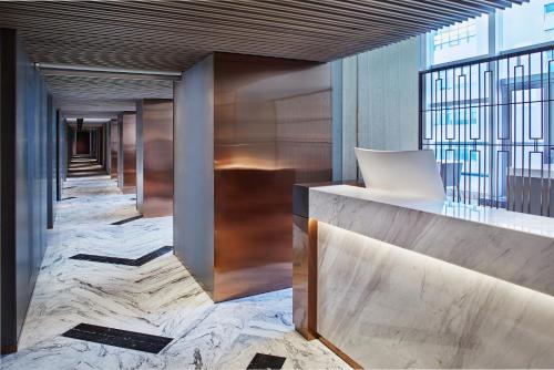 a lobby of a building with marble floors at Park Plaza Beijing Science Park in Beijing