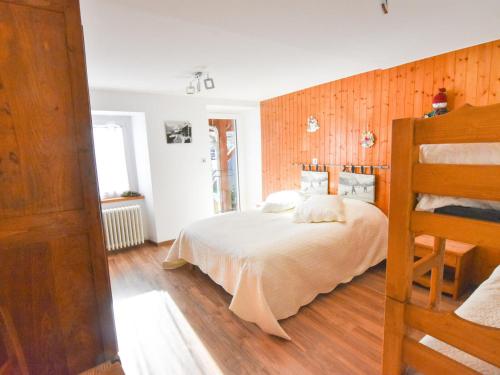 a bedroom with a bed and a wooden wall at Appartement Valloire, 3 pièces, 6 personnes - FR-1-263-404 in Valloire