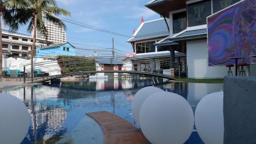 a bridge over a body of water with buildings at The Yorkshire Hotel - SHA Certified in Patong Beach