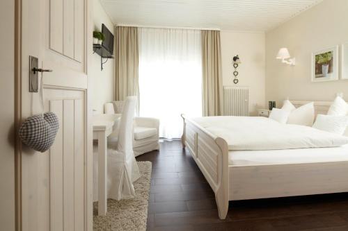 a hotel room with two beds and a sink at Hotel Pfälzer Hof in Lauterecken