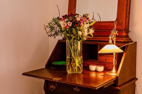 a vase filled with flowers on top of a wooden table at The Babe Boutique Hotel in Belgrade