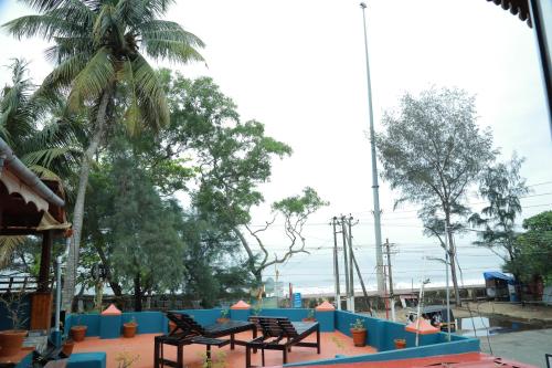 two benches sitting on a table in a park at Sajeev Home Stay in Cherai Beach