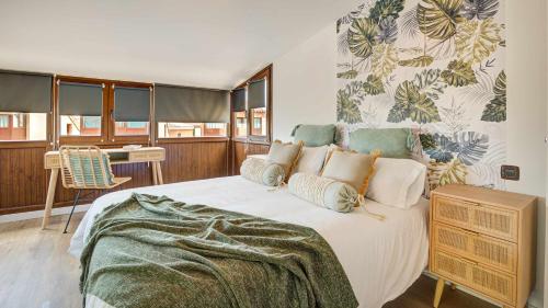 a bedroom with a large bed and a table at Tinajas Chic in Corralejo